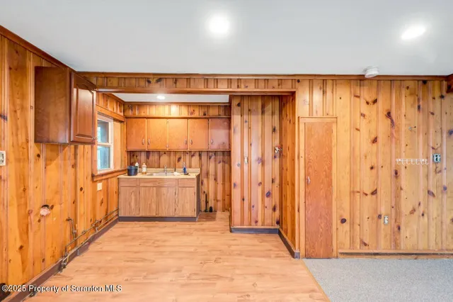 a view of an empty room with wooden walls