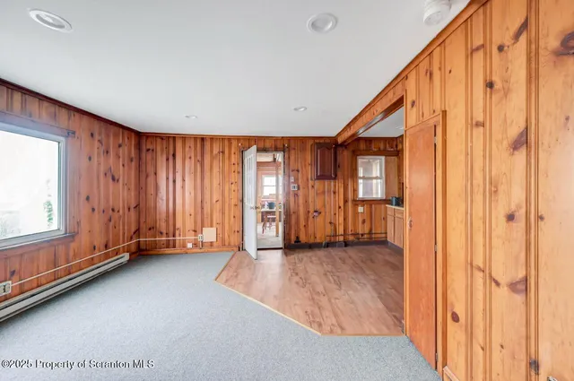 a view of a livingroom with a computer on the desk and chair