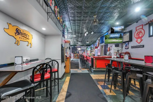 a living room with furniture a rug and a window