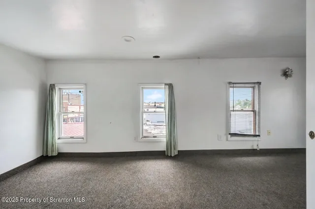 a view of empty room with windows