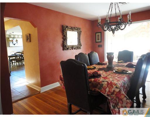 6 Lawton Road Bridgewater, NJ 08807 - Photo 11 of 25 a view of a dining room with furniture a chandelier and wooden floor