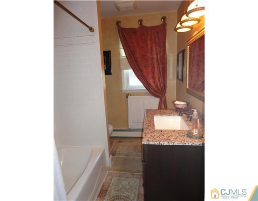 6 Lawton Road Bridgewater, NJ 08807 - Photo 18 of 25 a bathroom with a granite countertop sink and a mirror