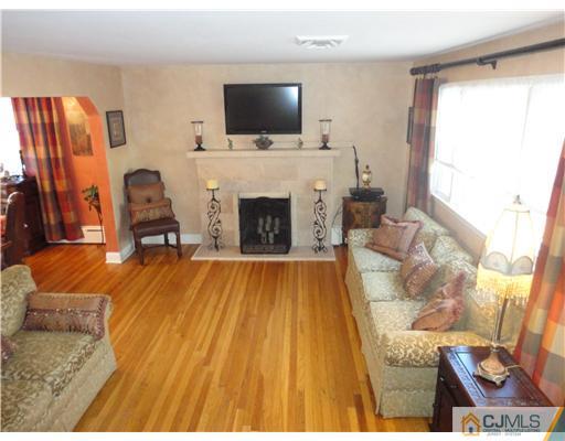 6 Lawton Road Bridgewater, NJ 08807 - Photo 3 of 25 a living room with furniture and a fireplace