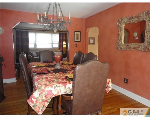 6 Lawton Road Bridgewater, NJ 08807 - Photo 10 of 25 a living room with dining table and wooden floor