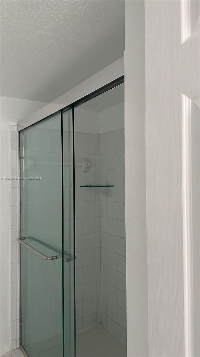 15430 Southwest 284th Street, Unit 6202 Homestead, FL 33033 - Photo 14 of 17 a bathroom with a glass shower door