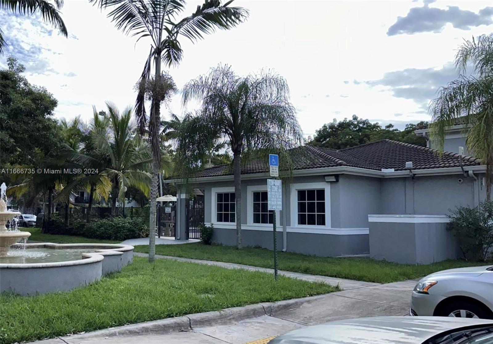 15430 Southwest 284th Street, Unit 6202 Homestead, FL 33033 - Photo 16 of 17 a front view of a house with a garden and trees