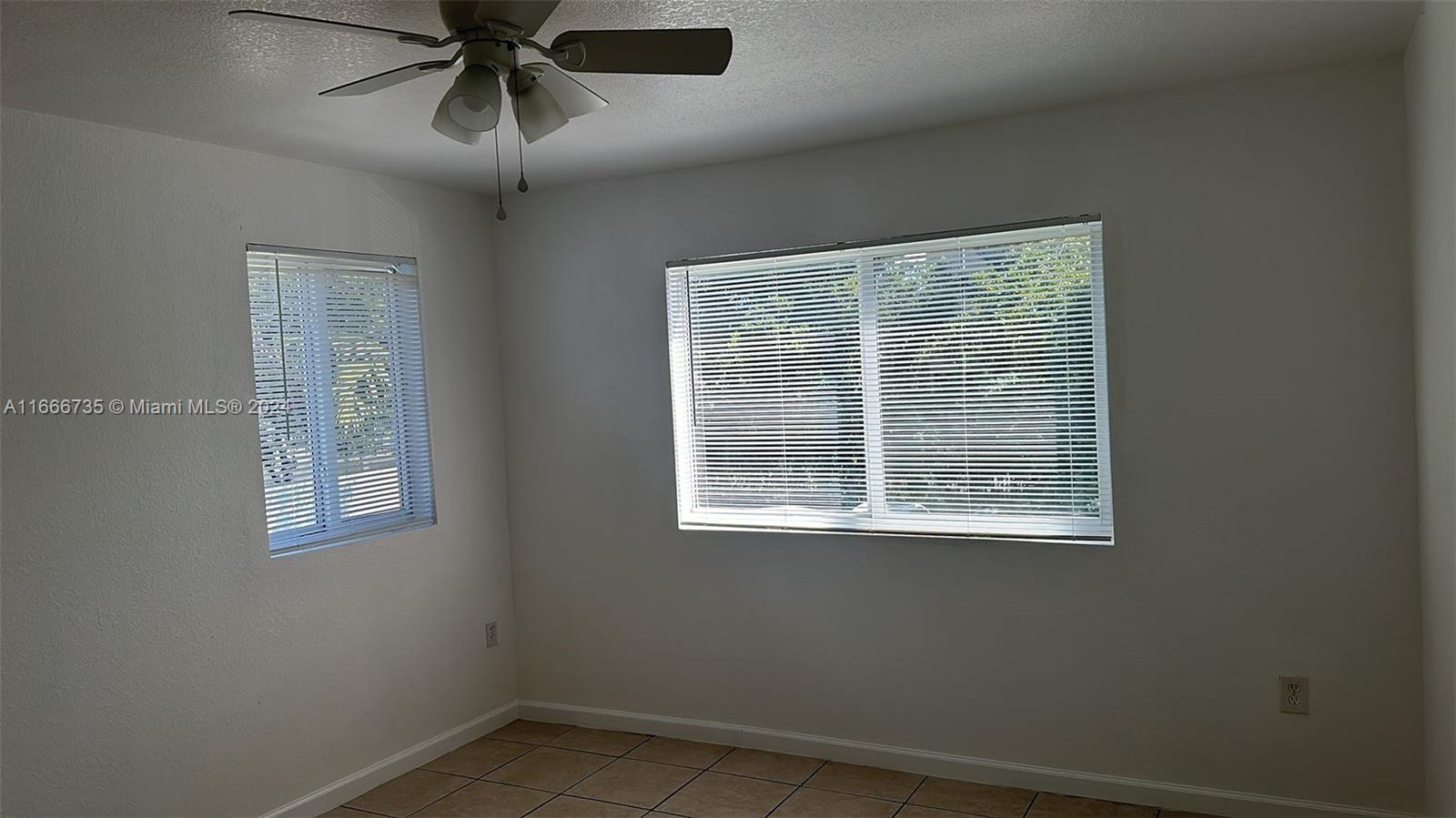 15430 Southwest 284th Street, Unit 6202 Homestead, FL 33033 - Photo 6 of 17 a view of an empty room with a window