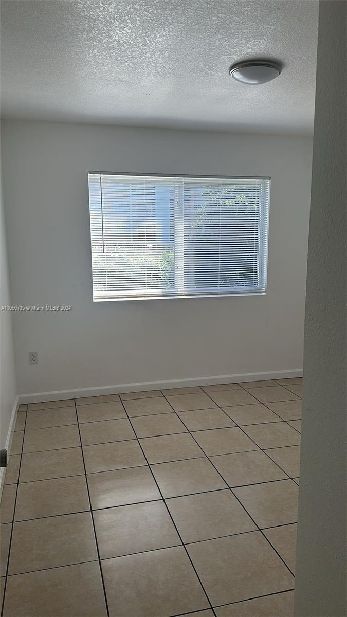 15430 Southwest 284th Street, Unit 6202 Homestead, FL 33033 - Photo 8 of 17 a view of an empty room with a window