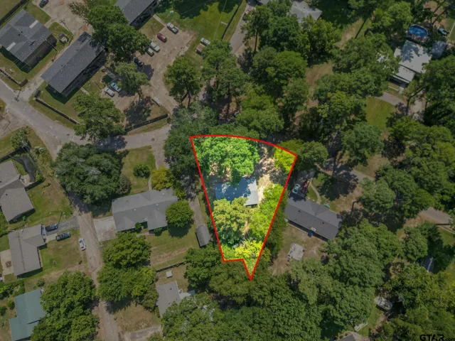 an aerial view of a house with outdoor space