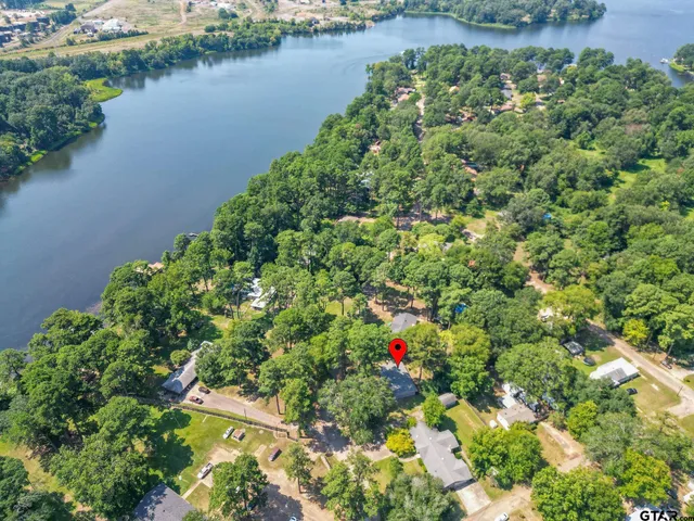 an aerial view of residential house with outdoor space and lake view