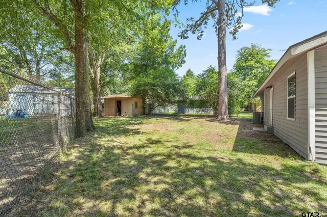 a backyard of a house with table and chairs