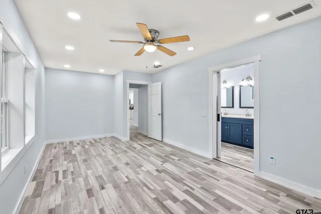 a view of an empty room and window with wooden floor