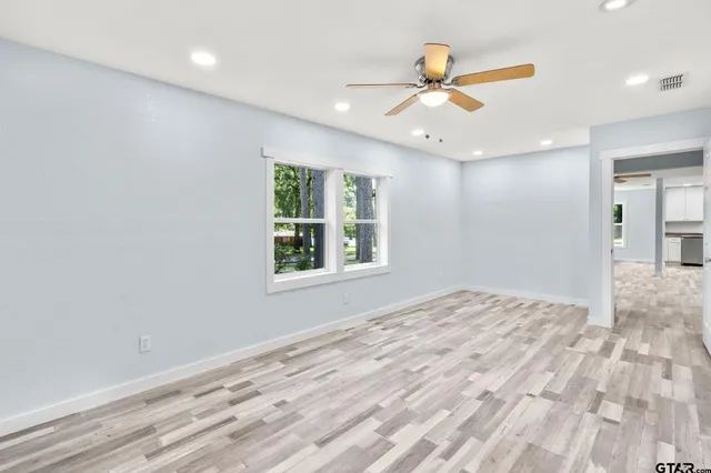 a view of a livingroom with a ceiling fan and window
