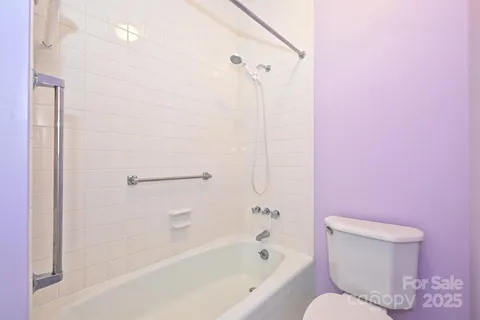 a bathroom with a toilet and a bathtub