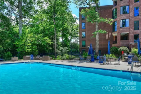 a view of a patio with a table chairs and a fire pit