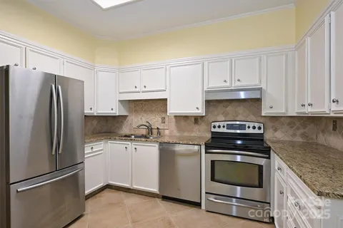 a kitchen with cabinets appliances and a counter space