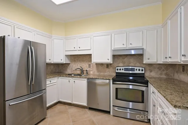 a kitchen with cabinets appliances and a counter space