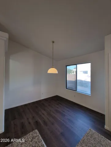 a view of a room with window and wooden floor