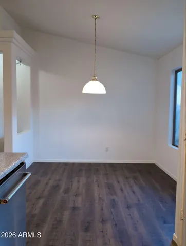 a view of a room with wooden floor and windows