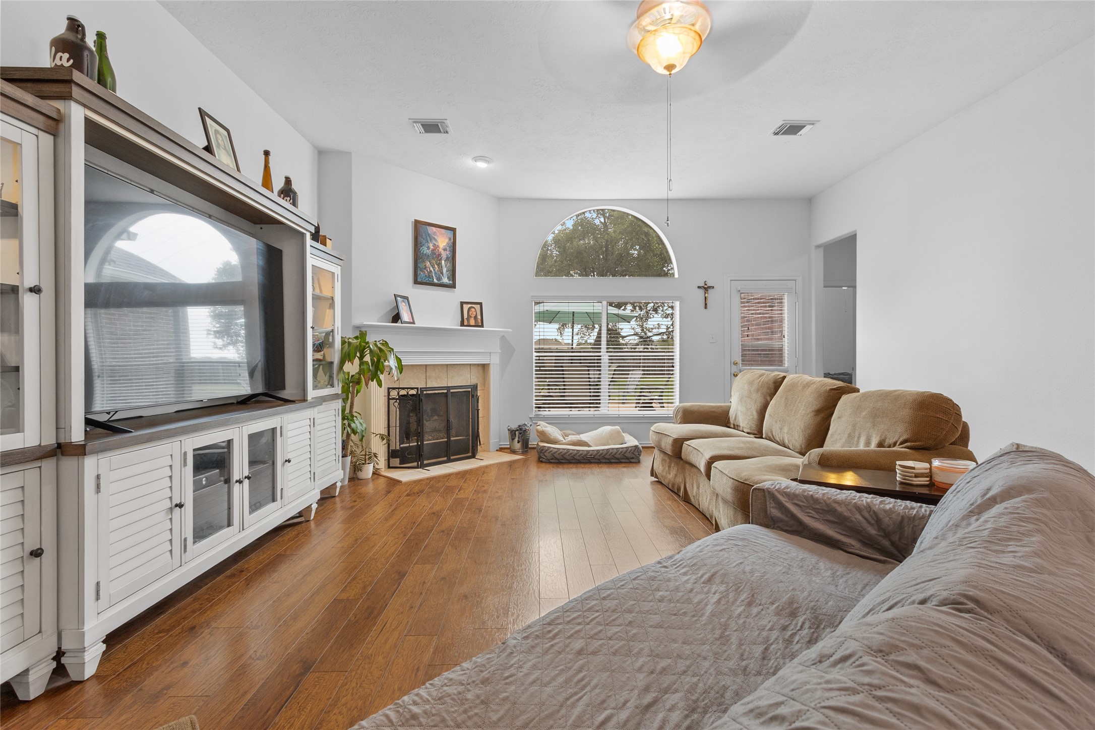 21014 Jessica Rose Lane Spring, TX 77379 - Photo 6 of 30 a living room with furniture a flat screen tv and a fireplace