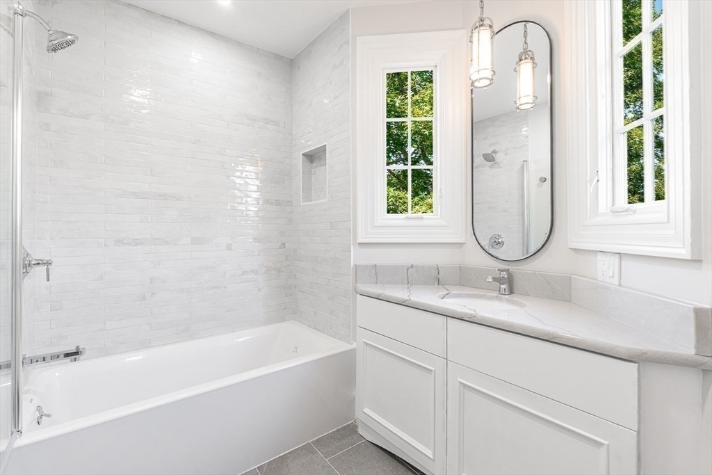 6 Lakeview Road Winchester, MA 01890 - Photo 30 of 42 a bathroom with a granite countertop sink a toilet and a bathtub