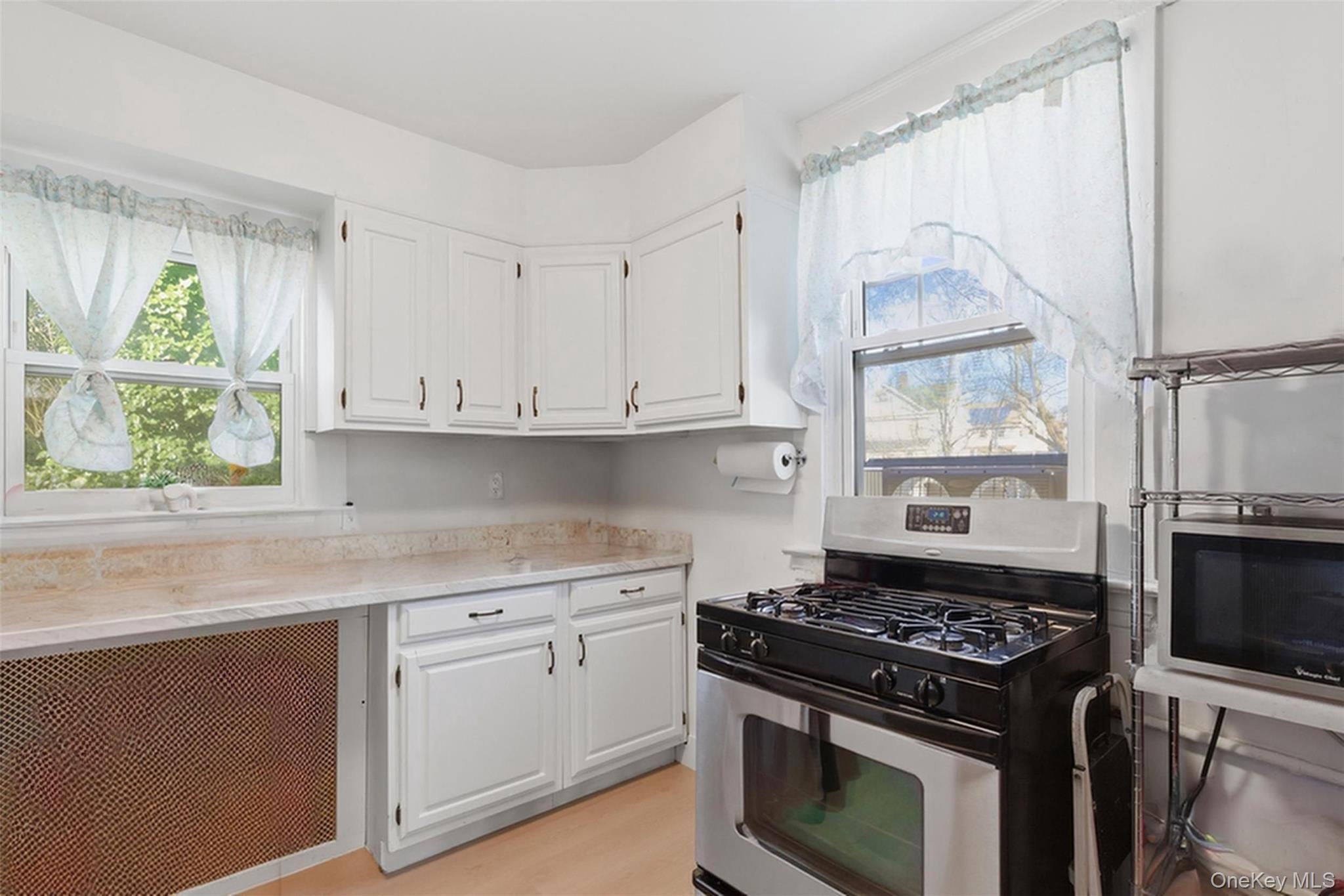 3 Hamilton Avenue Ossining, NY 10562 - Photo 14 of 48 a kitchen with stainless steel appliances a stove a sink and a window
