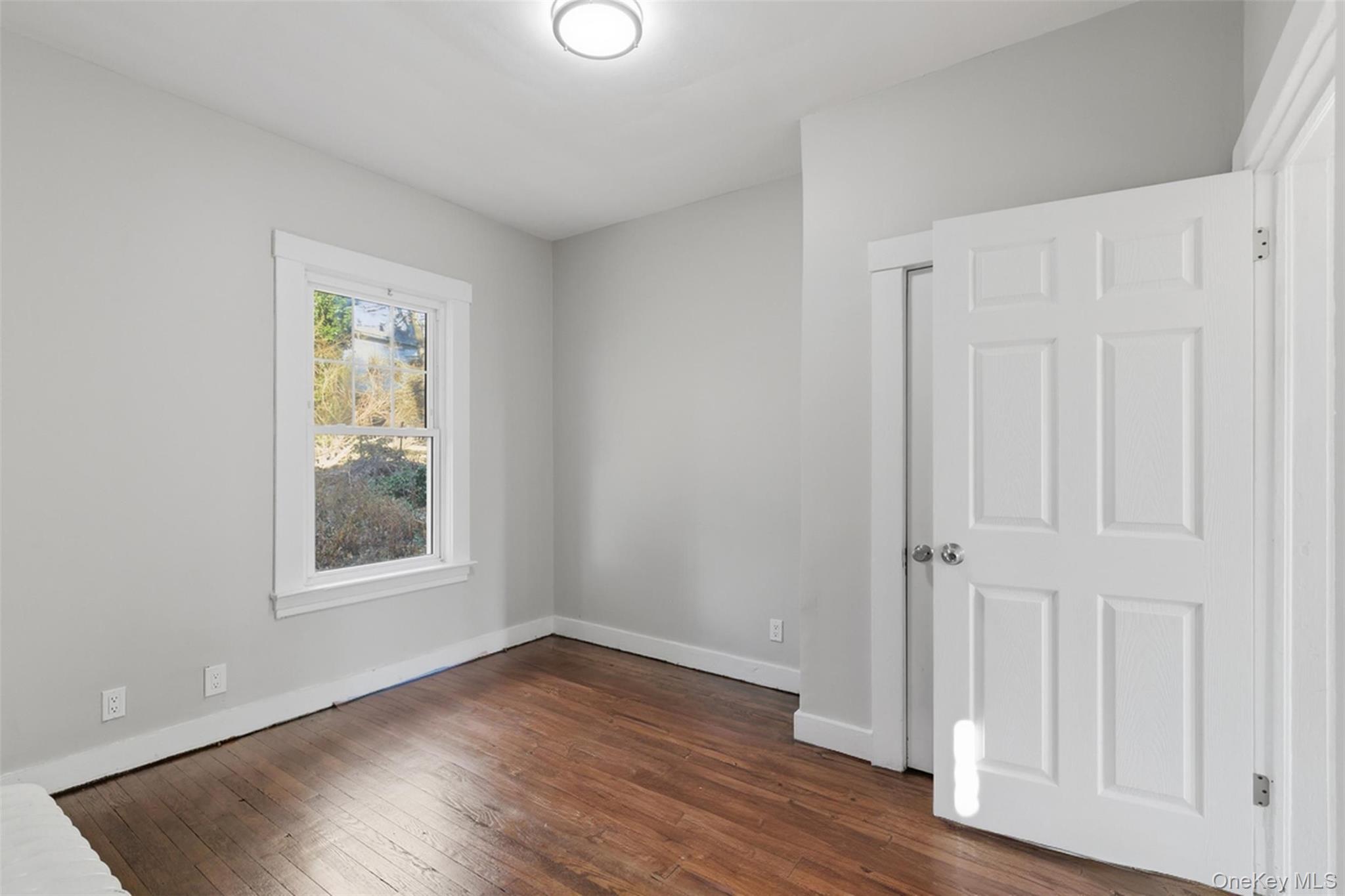 3 Hamilton Avenue Ossining, NY 10562 - Photo 17 of 48 an empty room with wooden floor and windows