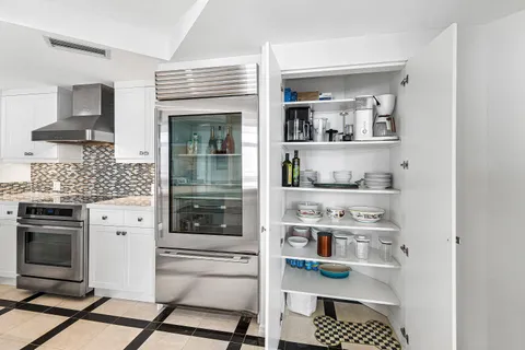 a kitchen with stainless steel appliances cabinets and a window
