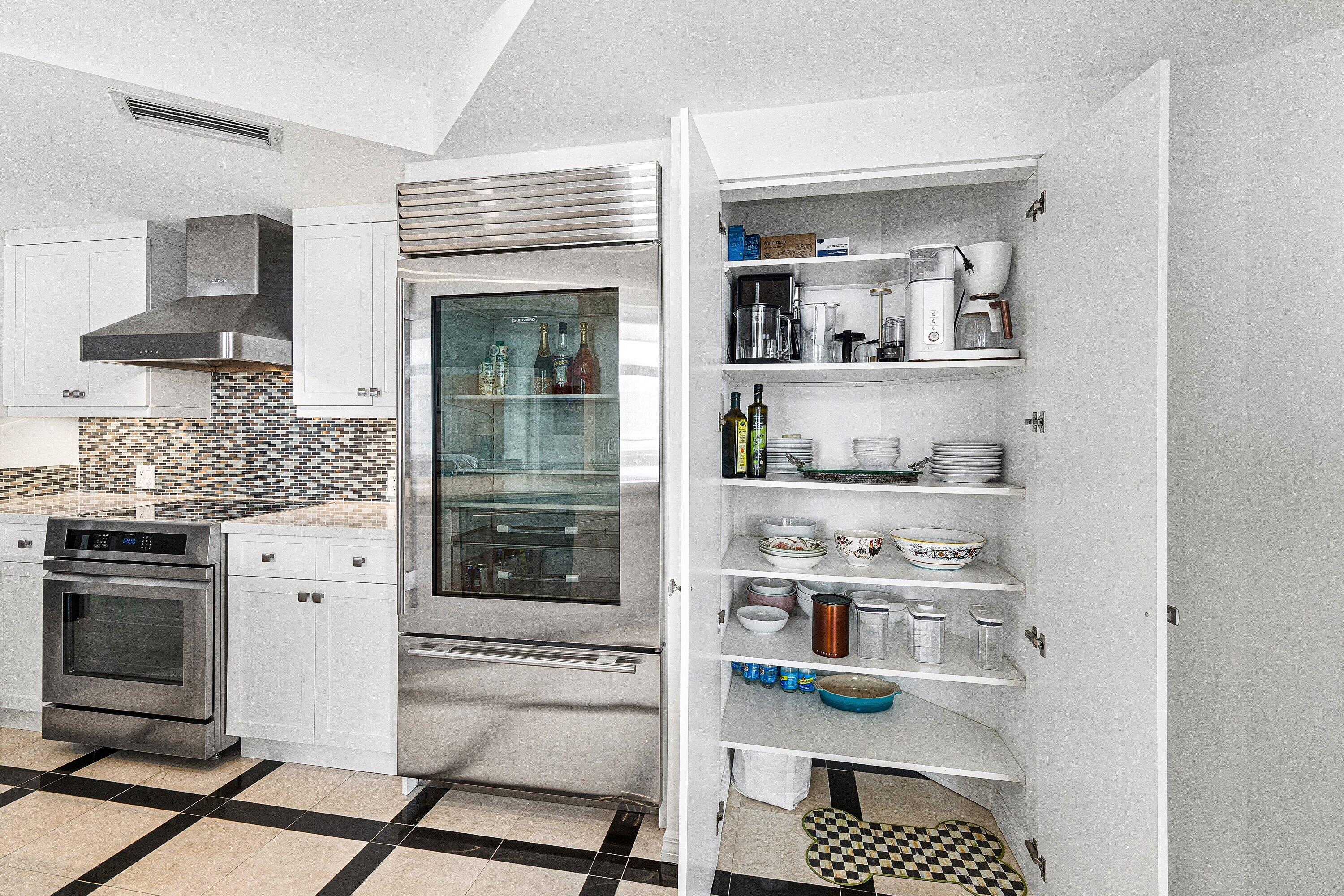 300 Southeast 5th Avenue, Unit PH 8120 Boca Raton, FL 33432 - Photo 12 of 54 a kitchen with stainless steel appliances cabinets and a window