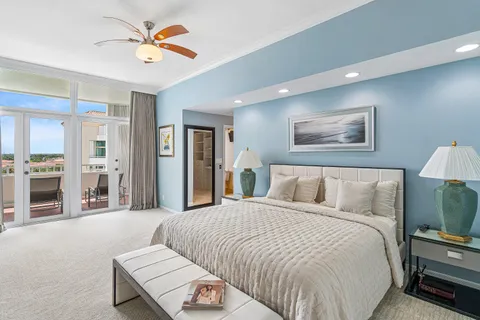 a spacious bedroom with a bed and a chandelier