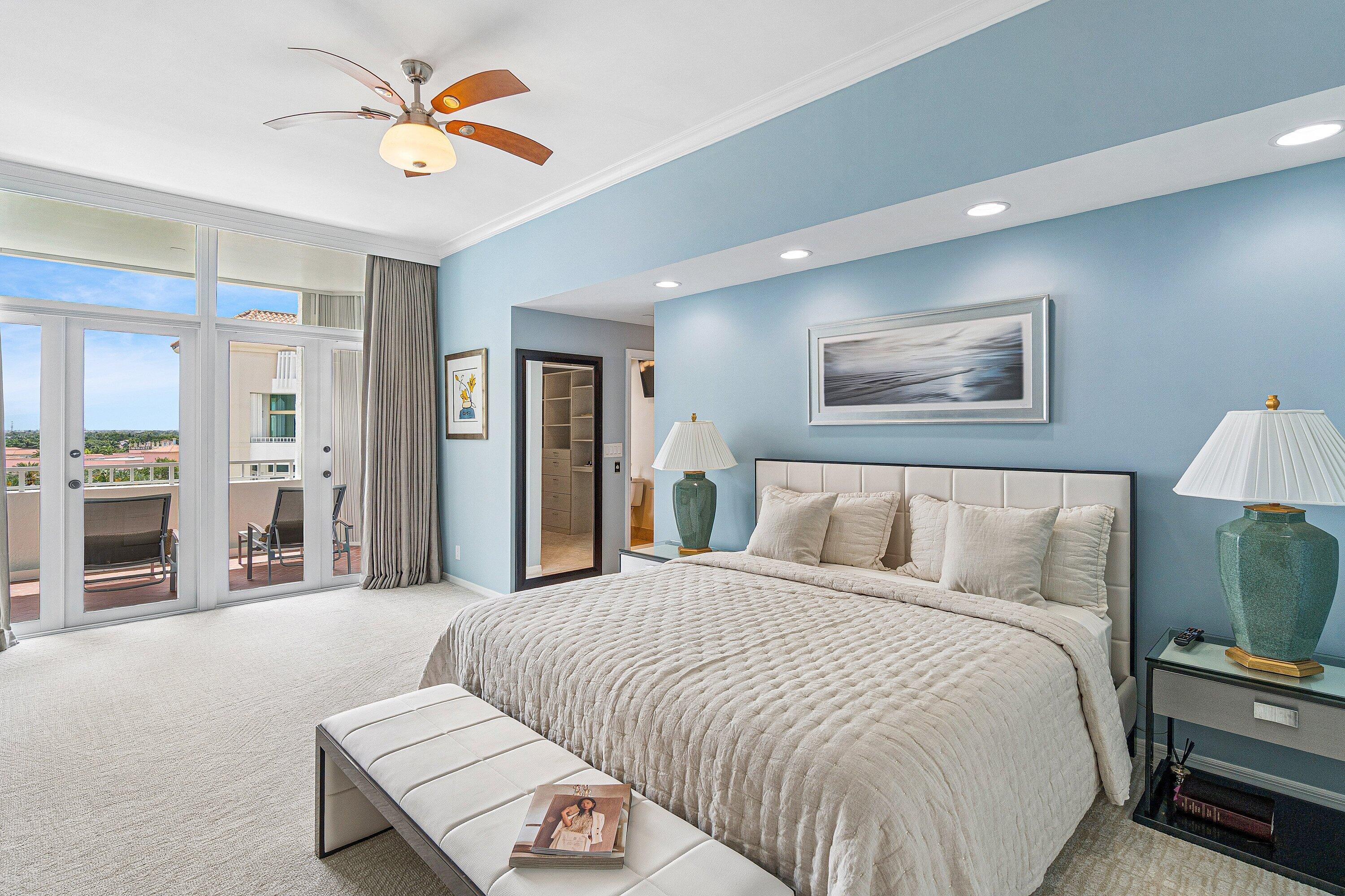 300 Southeast 5th Avenue, Unit PH 8120 Boca Raton, FL 33432 - Photo 14 of 54 a spacious bedroom with a bed and a chandelier