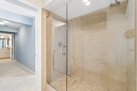 a bathroom with a granite countertop toilet sink and mirror