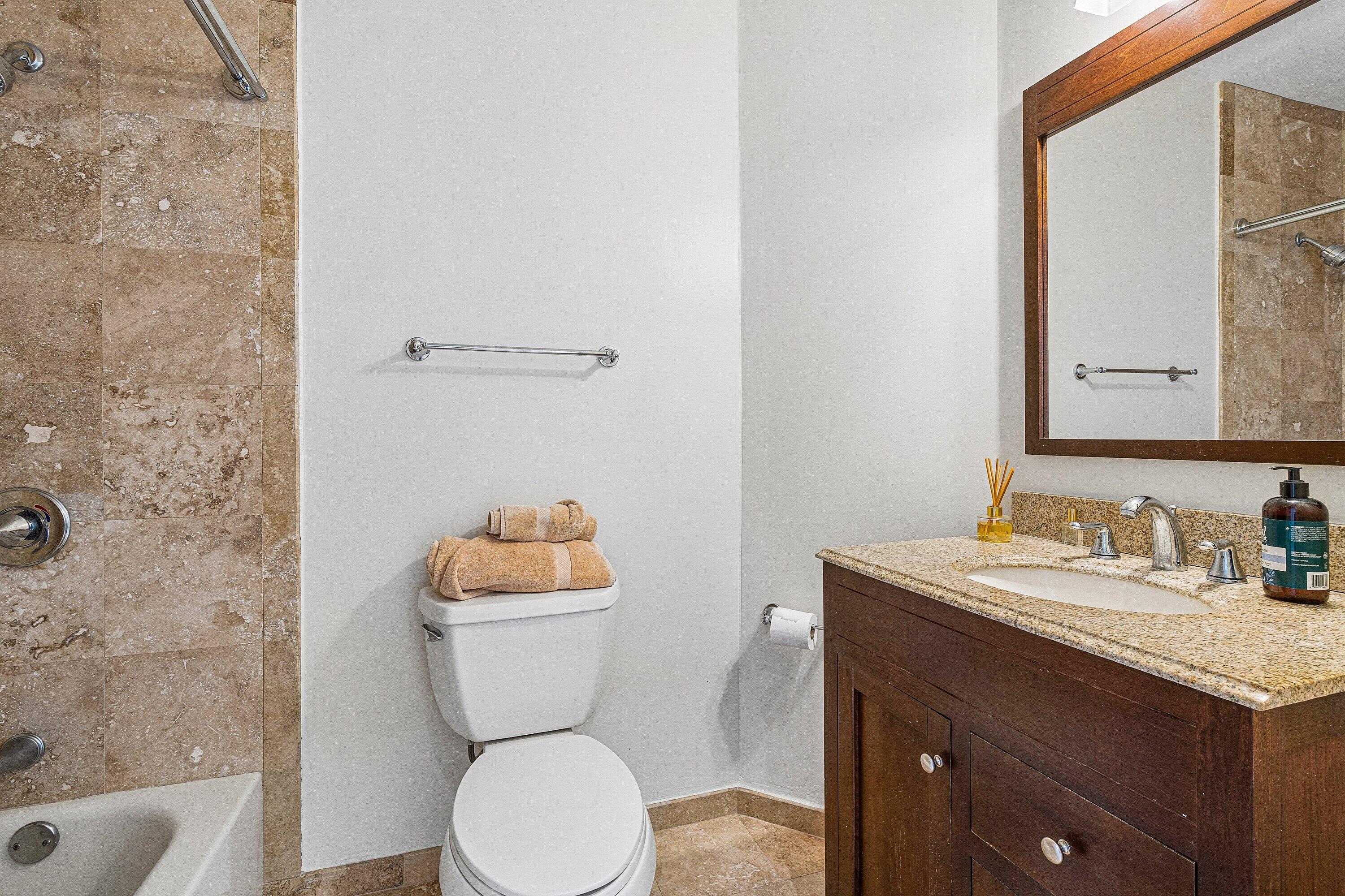 300 Southeast 5th Avenue, Unit PH 8120 Boca Raton, FL 33432 - Photo 20 of 54 a bathroom with a granite countertop toilet sink and mirror