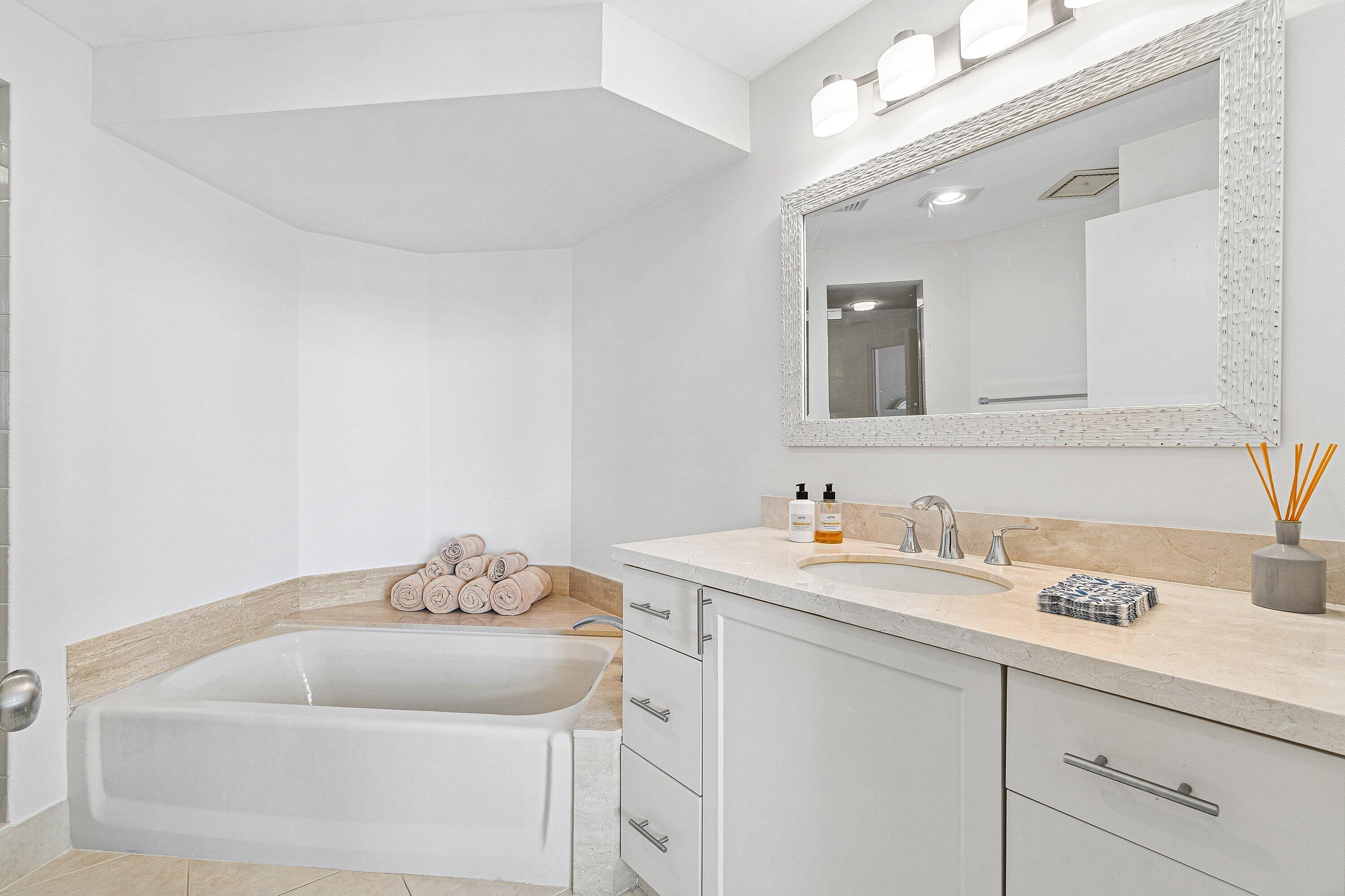 300 Southeast 5th Avenue, Unit PH 8120 Boca Raton, FL 33432 - Photo 23 of 54 a bathroom with a sink and a mirror