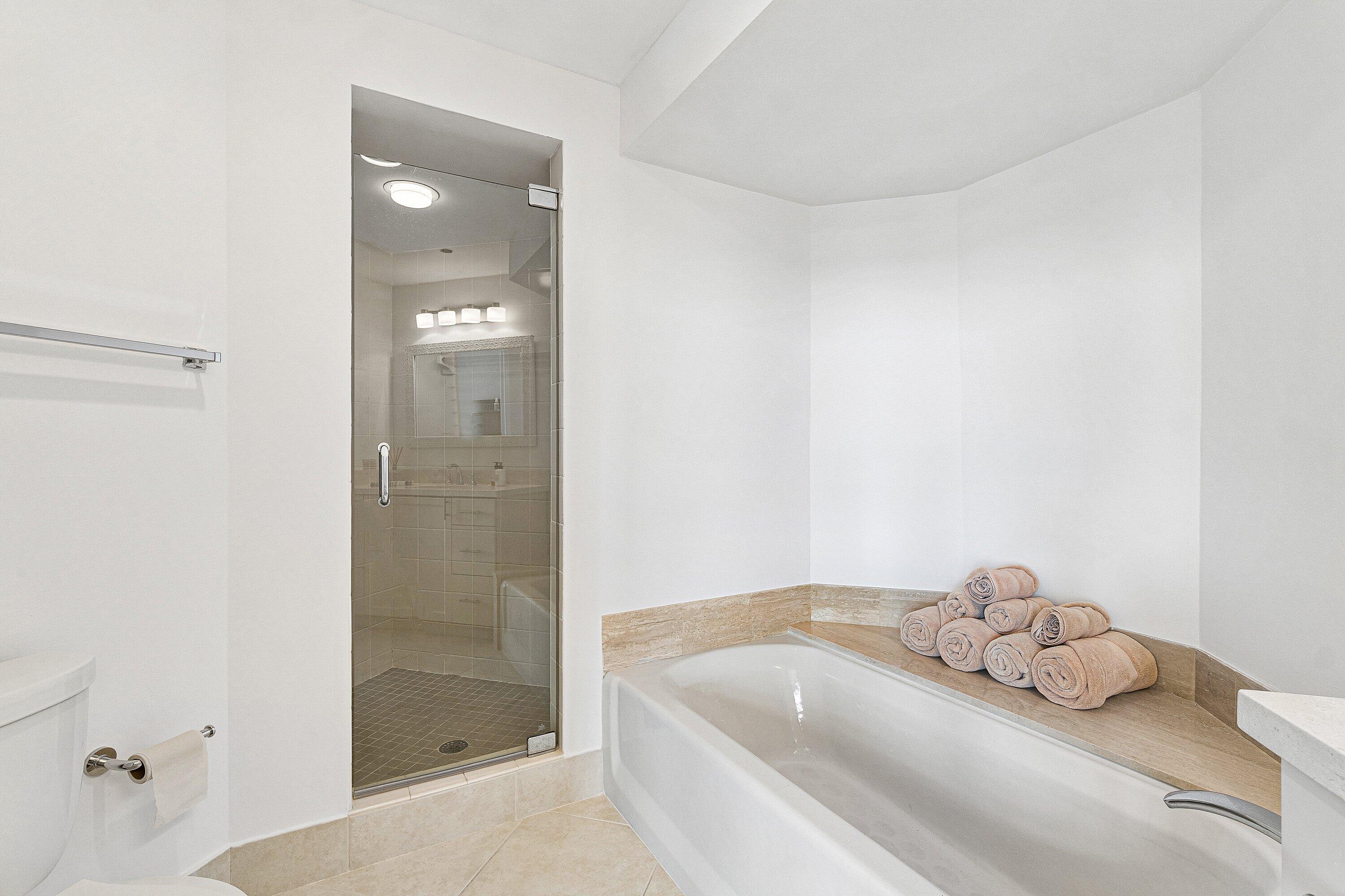 300 Southeast 5th Avenue, Unit PH 8120 Boca Raton, FL 33432 - Photo 27 of 54 a bathroom with a bathtub and shower