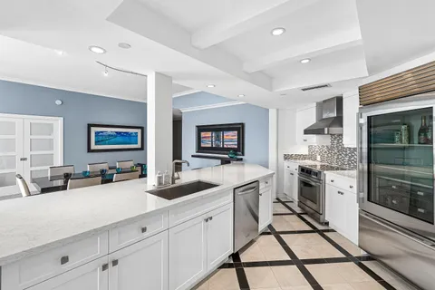 a kitchen with stainless steel appliances granite countertop a sink and cabinets