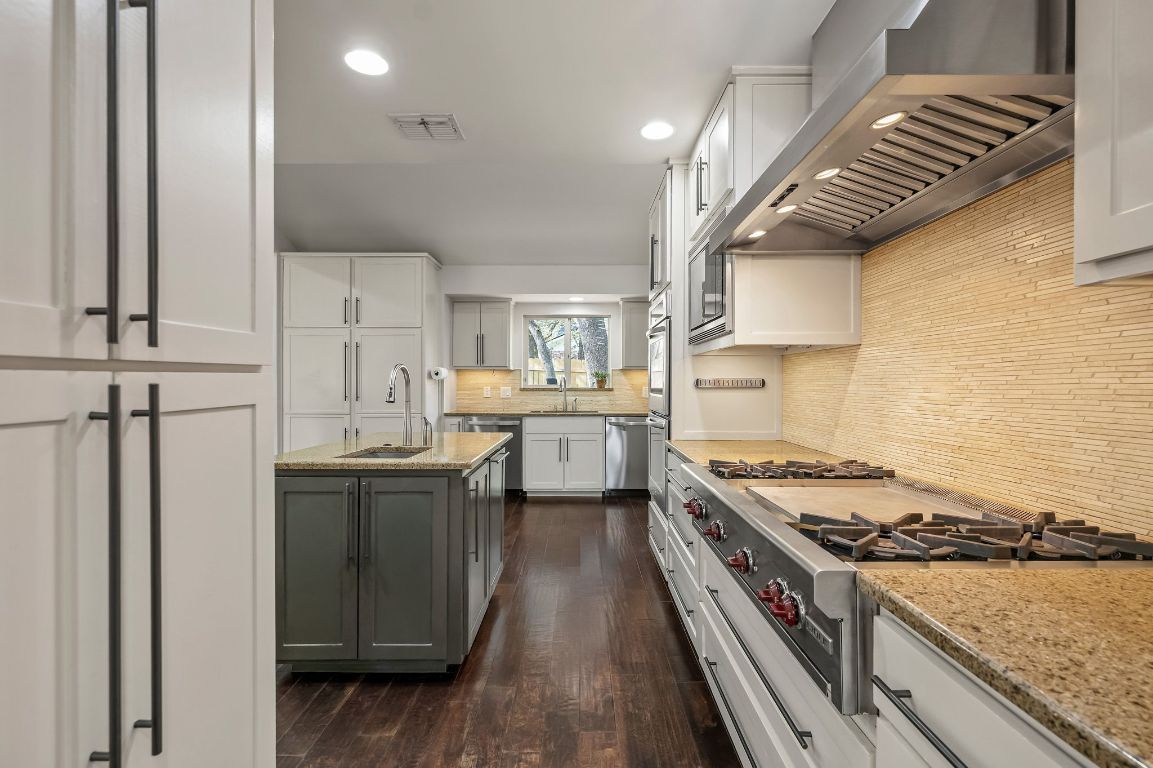7202 Running Rope Circle Austin, TX 78731 - Photo 12 of 40 a kitchen with stainless steel appliances a sink a stove and a refrigerator