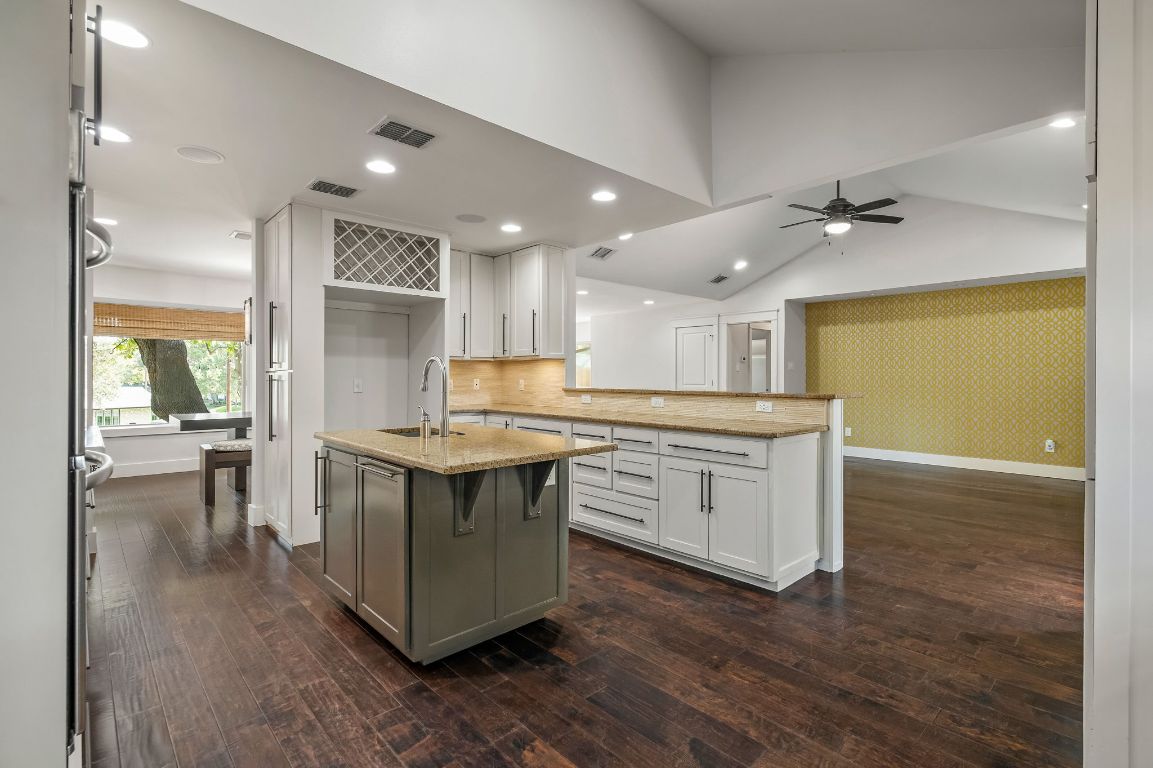 7202 Running Rope Circle Austin, TX 78731 - Photo 13 of 40 a kitchen with stainless steel appliances granite countertop a stove and a sink