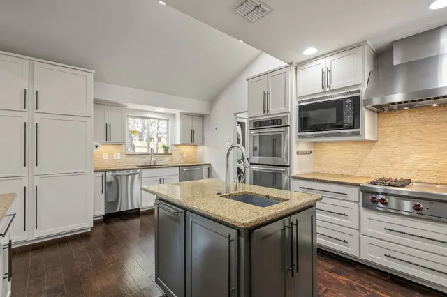 a view of kitchen with furniture and refrigerator