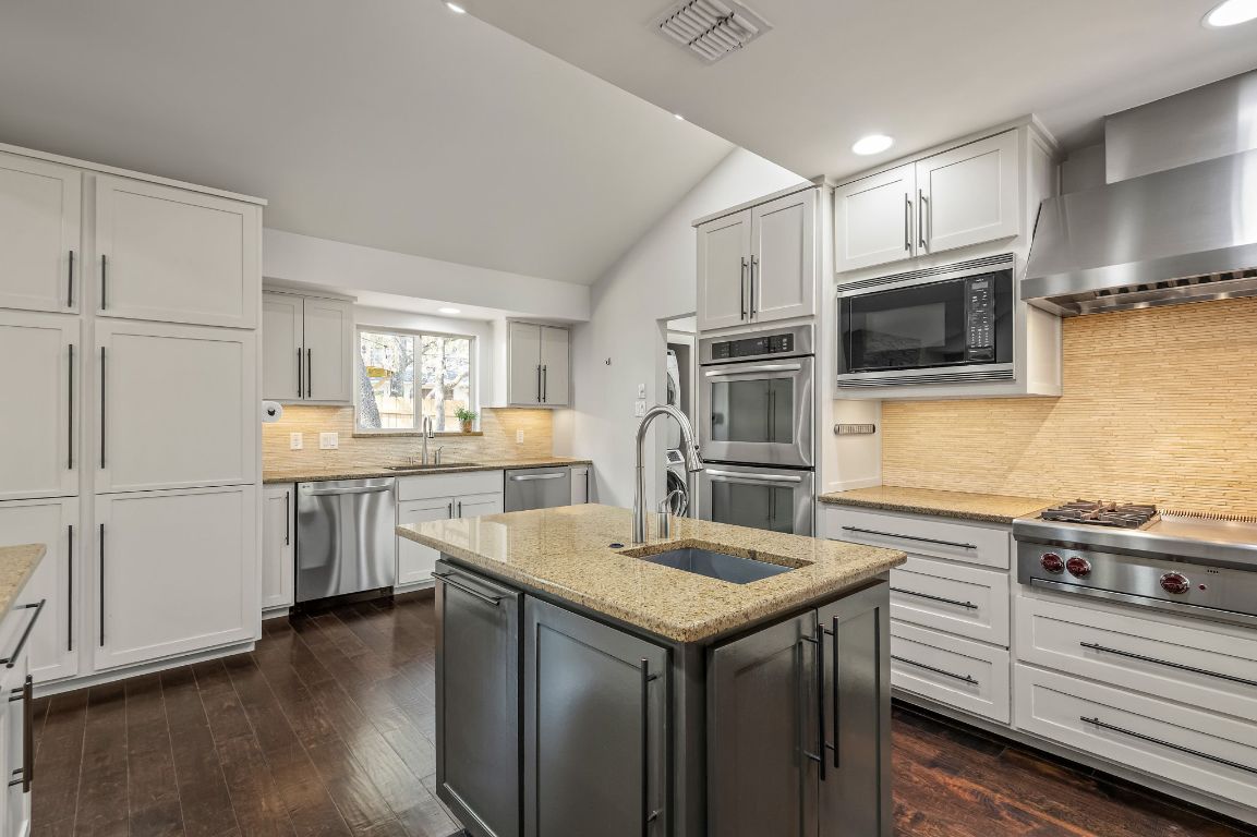 7202 Running Rope Circle Austin, TX 78731 - Photo 14 of 40 a kitchen with a sink microwave and refrigerator