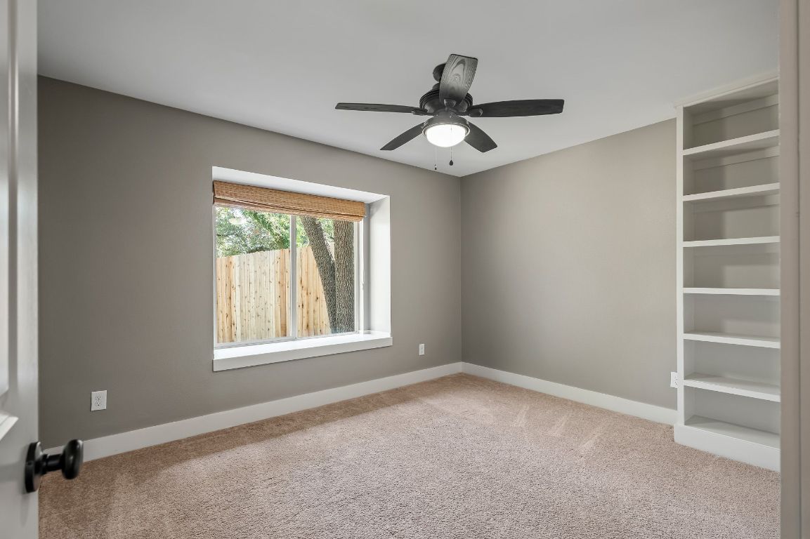 7202 Running Rope Circle Austin, TX 78731 - Photo 22 of 40 a view of an empty room with a window and a ceiling fan