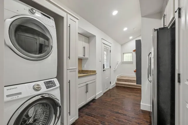 a kitchen with stainless steel appliances granite countertop a refrigerator and a sink