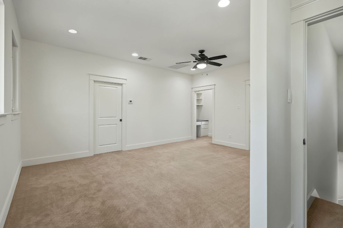 7202 Running Rope Circle Austin, TX 78731 - Photo 29 of 40 a view of an empty room with a ceiling fan