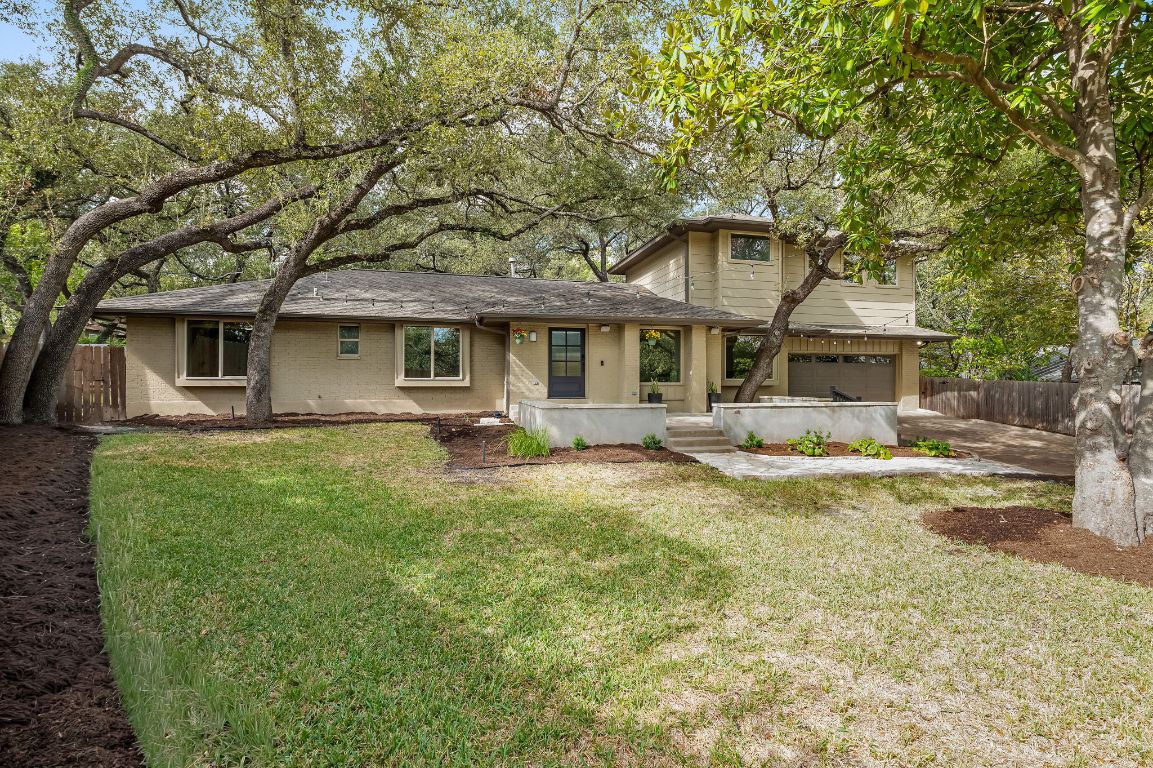 7202 Running Rope Circle Austin, TX 78731 - Photo 3 of 40 a front view of a house with yard and green space