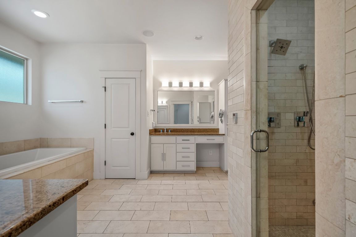 7202 Running Rope Circle Austin, TX 78731 - Photo 32 of 40 a bathroom with a granite countertop sink a toilet and shower