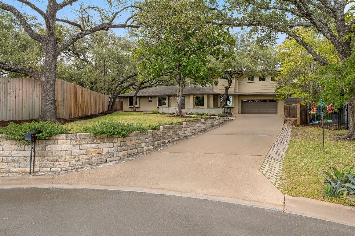 7202 Running Rope Circle Austin, TX 78731 - Photo 4 of 40 front view of a house with a patio