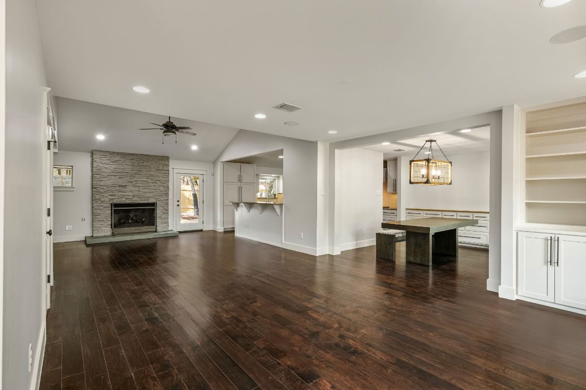 7202 Running Rope Circle Austin, TX 78731 - Photo 5 of 40 an empty room with wooden floor and a kitchen