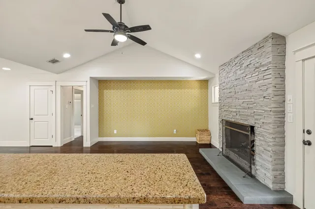 an open kitchen with white cabinets and chandelier