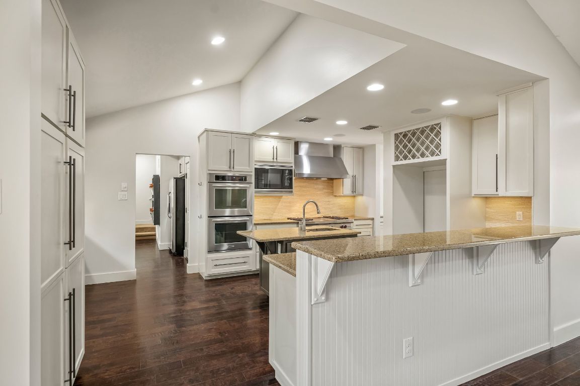 7202 Running Rope Circle Austin, TX 78731 - Photo 10 of 40 a kitchen with stainless steel appliances granite countertop a refrigerator a stove and a sink