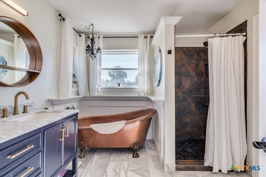171 Pin Oak Crossing Elgin, TX 78621 - Photo 21 of 38 a bathroom with a tub sink and mirror